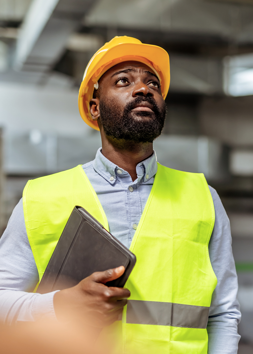 a man in a hard hat and high vis vest